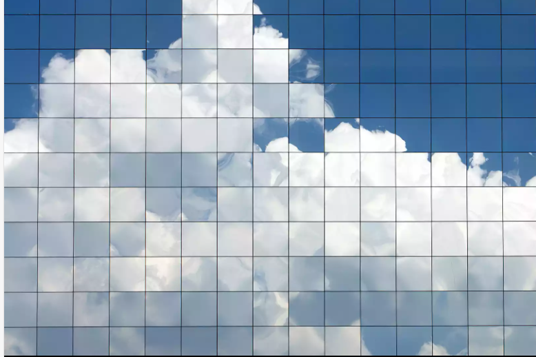 Cloud reflections on a modern glass building